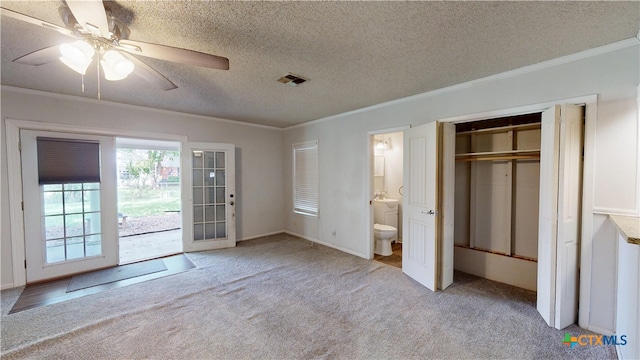 4610 Camellia St, Victoria, TX 77904 - unfurnished bedroom featuring carpet, ornamental molding, a textured ceiling, ensuite bath, and ceiling fan