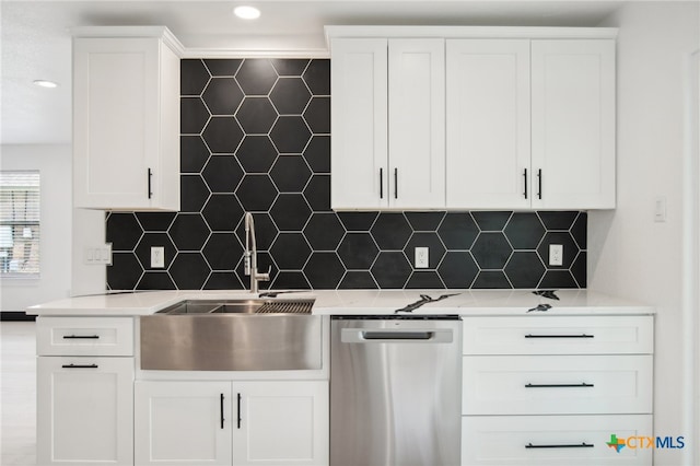 kitchen with white cabinetry, stainless steel dishwasher, and tasteful backsplash