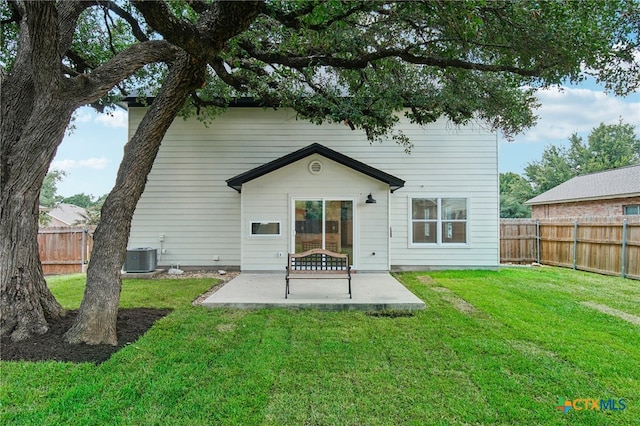 back of house with a patio, central air condition unit, and a lawn