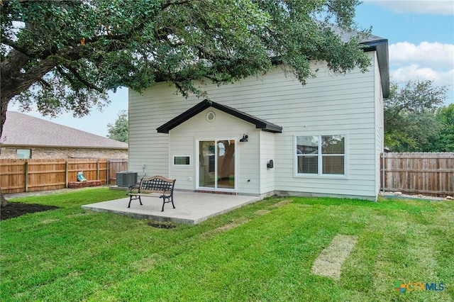 rear view of house with a lawn, a patio, and central AC