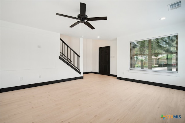 unfurnished living room with ceiling fan and light wood-type flooring