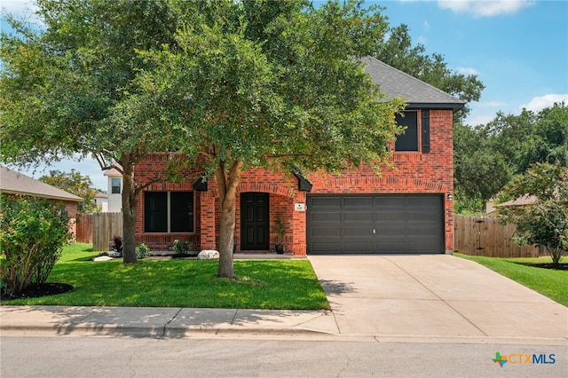 view of front of house with a garage and a front lawn