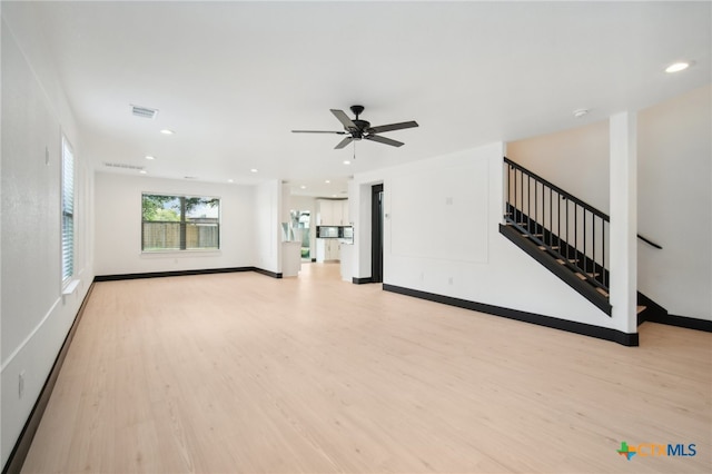 unfurnished living room with light hardwood / wood-style flooring and ceiling fan