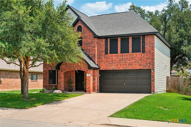 view of front of house with a garage and a front yard