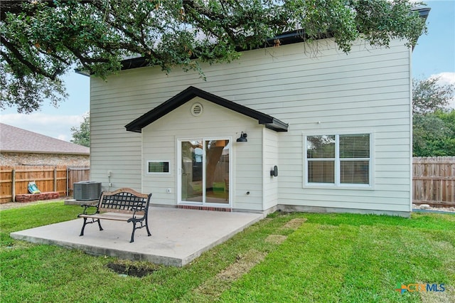 back of house featuring a patio, cooling unit, and a lawn