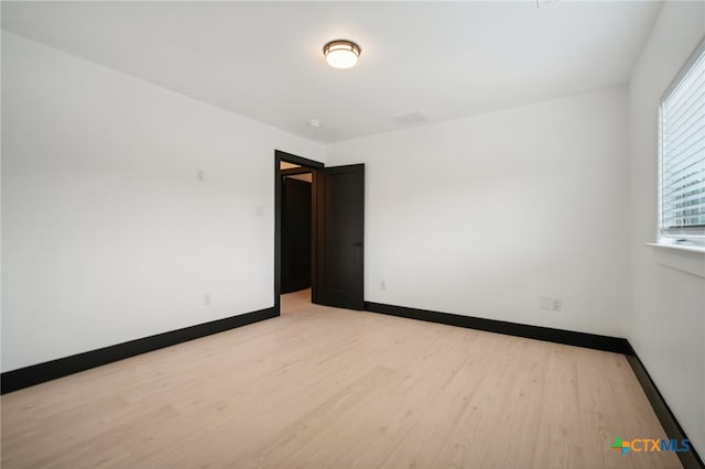 spare room with light hardwood / wood-style floors