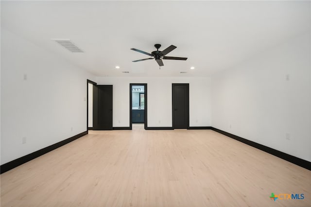 empty room featuring ceiling fan and light wood-type flooring