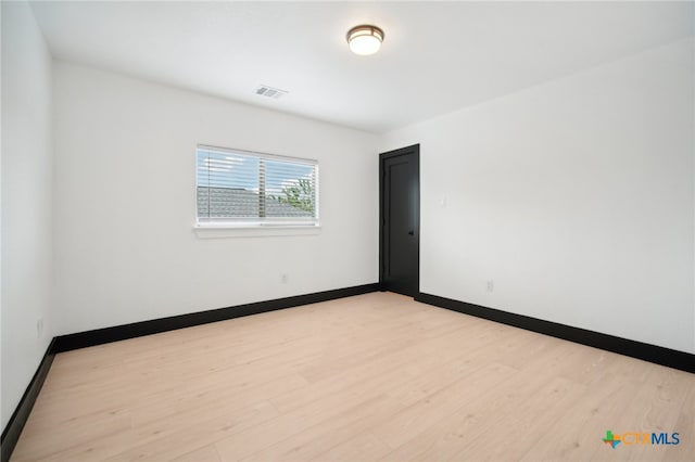 spare room with light wood-type flooring