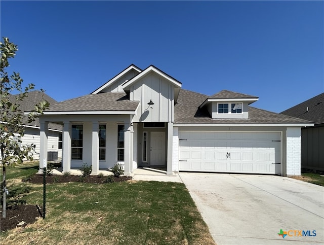 view of front of property with a garage and a front lawn