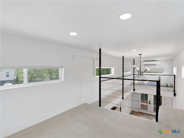 corridor with a wall mounted air conditioner, baseboards, an upstairs landing, and recessed lighting