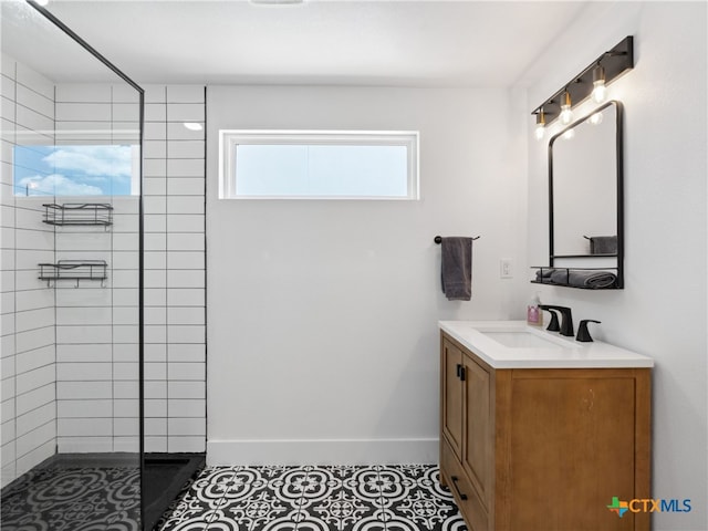 bathroom featuring baseboards, vanity, and tiled shower