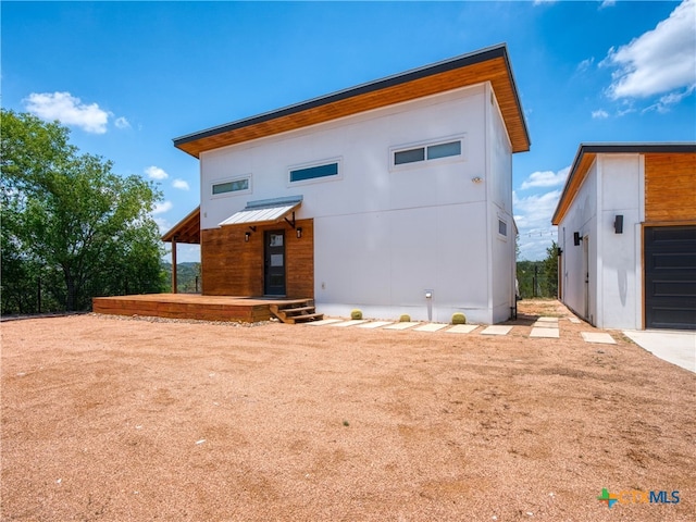 back of property featuring a standing seam roof and metal roof
