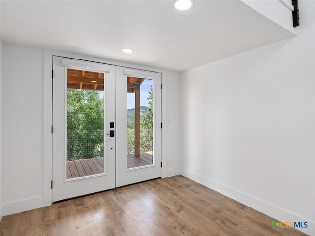 entryway with baseboards, french doors, wood finished floors, and recessed lighting