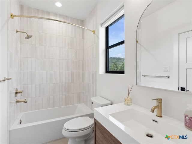 bathroom featuring recessed lighting, toilet, vanity, and bathing tub / shower combination