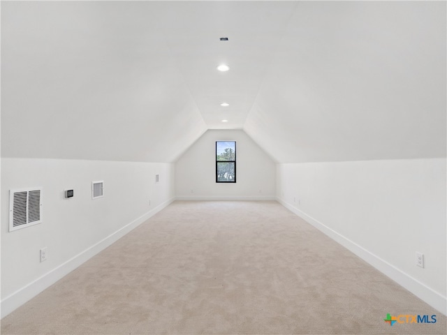 bonus room with vaulted ceiling, visible vents, and baseboards