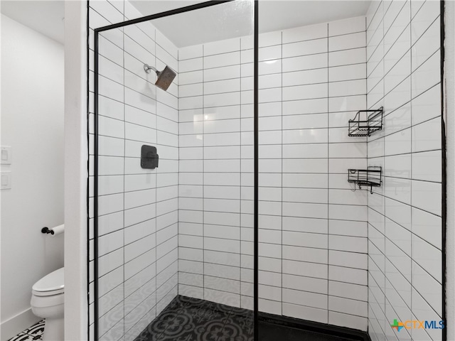 full bathroom with a shower stall and toilet