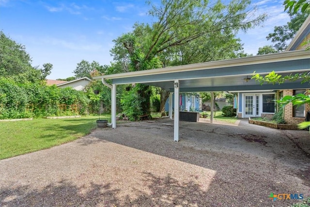 910 Mill Creek Dr, Salado, TX 76571 - view of parking / parking lot with french doors, driveway, and a carport