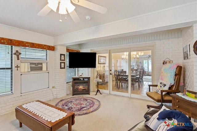 910 Mill Creek Dr, Salado, TX 76571 - carpeted living room with cooling unit, brick wall, ceiling fan, and a lit fireplace