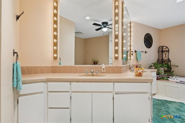 910 Mill Creek Dr, Salado, TX 76571 - full bath featuring vanity, ceiling fan, a bath, recessed lighting, and backsplash