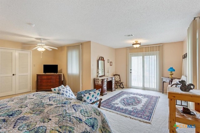 910 Mill Creek Dr, Salado, TX 76571 - carpeted bedroom featuring a textured ceiling, access to exterior, a ceiling fan, and a closet