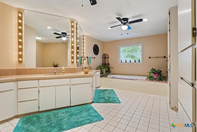 910 Mill Creek Dr, Salado, TX 76571 - full bathroom featuring a ceiling fan, vanity, a garden tub, tile patterned floors, and recessed lighting