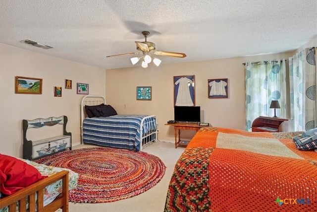 910 Mill Creek Dr, Salado, TX 76571 - bedroom featuring carpet, a textured ceiling, and a ceiling fan
