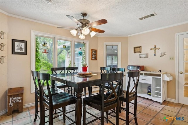 910 Mill Creek Dr, Salado, TX 76571 - dining area featuring a ceiling fan, ornamental molding, and a textured ceiling