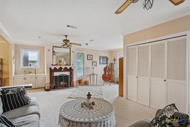 910 Mill Creek Dr, Salado, TX 76571 - living area with a ceiling fan, light carpet, ornamental molding, a textured ceiling, and a brick fireplace