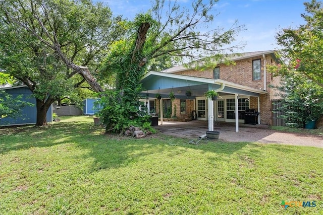 910 Mill Creek Dr, Salado, TX 76571 - back of house with brick siding, a patio area, and a shed