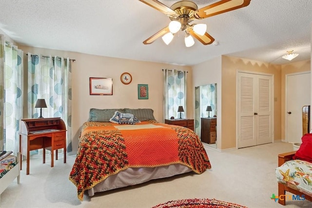 910 Mill Creek Dr, Salado, TX 76571 - bedroom with carpet floors, a textured ceiling, a ceiling fan, and a closet