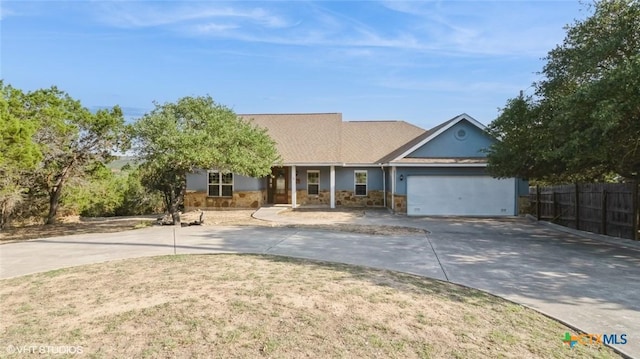 1974 Canyon Bnd, Canyon Lake, TX 78133 - ranch-style house with concrete driveway, stone siding, a garage, and stucco siding