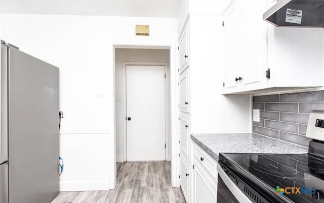 902 Concord Dr, Temple, TX 76504 - kitchen with appliances with stainless steel finishes, ventilation hood, light wood-style floors, white cabinetry, and backsplash