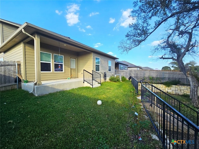 back of house with a yard