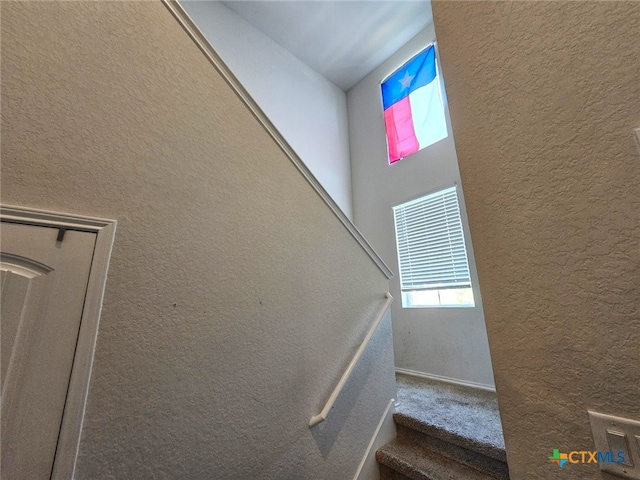 staircase featuring vaulted ceiling and a wealth of natural light