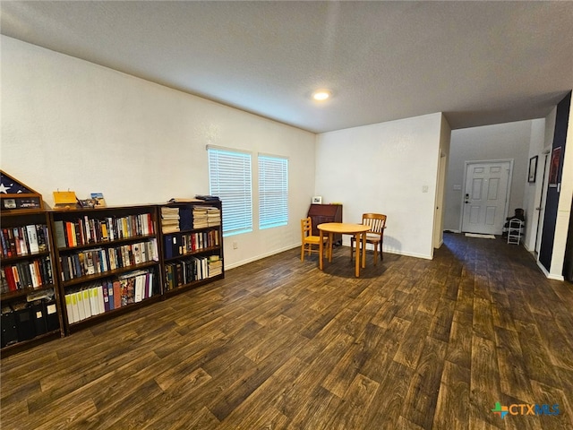 interior space featuring a textured ceiling and dark hardwood / wood-style floors