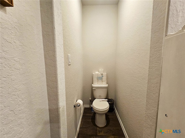 bathroom featuring hardwood / wood-style floors and toilet