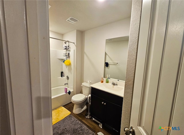 full bathroom featuring hardwood / wood-style flooring, vanity, toilet, and bathtub / shower combination