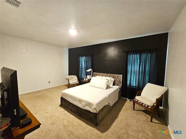 carpeted bedroom featuring a textured ceiling