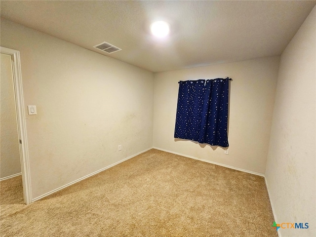 unfurnished room featuring light colored carpet