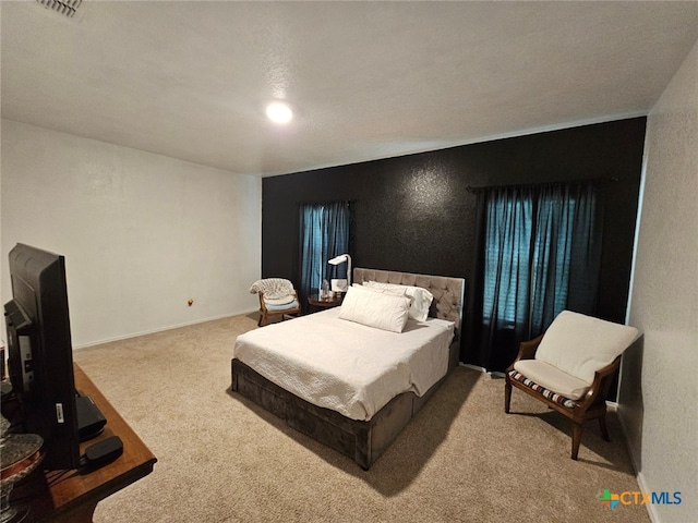 carpeted bedroom featuring a textured ceiling