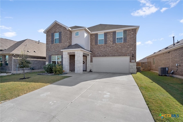 view of front property featuring a garage, cooling unit, and a front yard