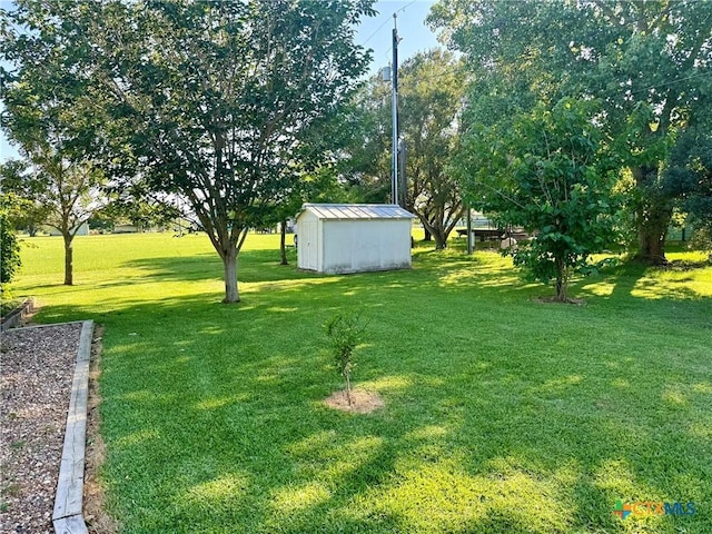 338 Calumet Dr, Palacios, TX 77465 - view of grassy yard with a storage shed and an outbuilding