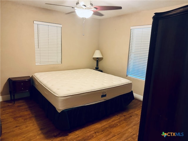 bedroom with dark wood-type flooring and ceiling fan