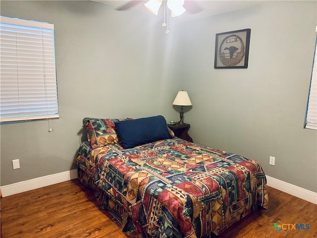 bedroom with ceiling fan and dark hardwood / wood-style floors