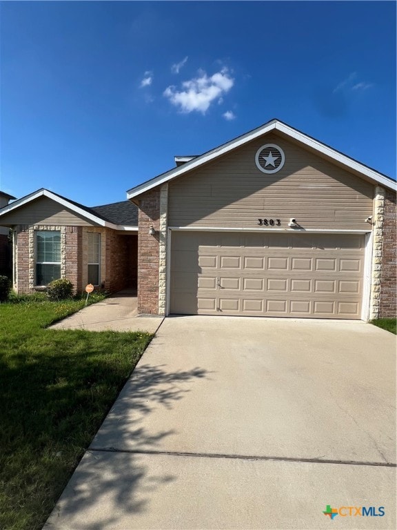 single story home with a garage and a front yard