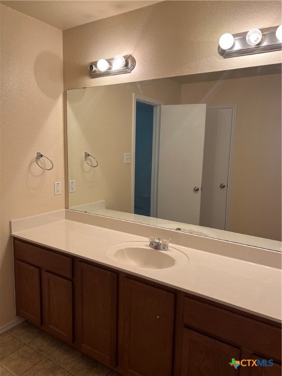 bathroom with vanity and tile patterned flooring