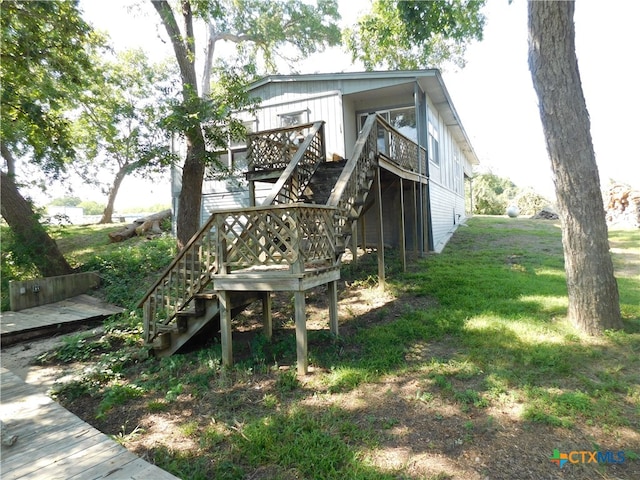 exterior space with a lawn and a deck