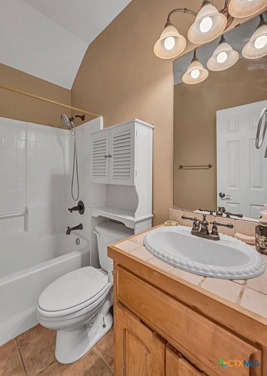 full bathroom featuring toilet,  shower combination, vaulted ceiling, vanity, and tile patterned flooring