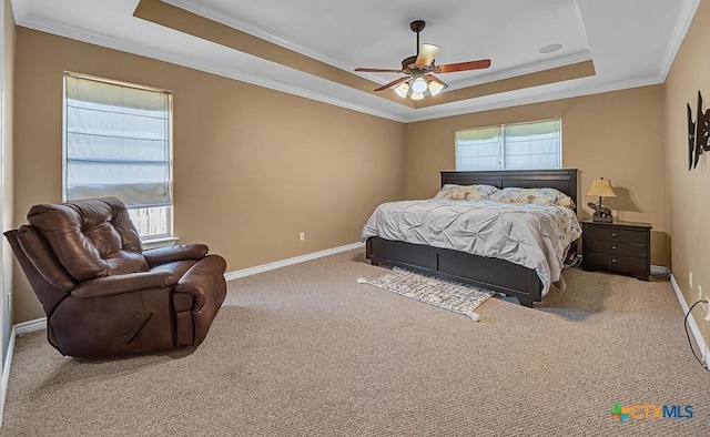 bedroom featuring a raised ceiling, ornamental molding, carpet flooring, and ceiling fan