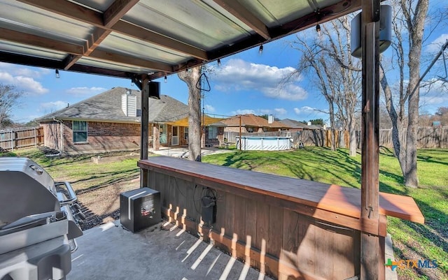 view of patio / terrace with a swimming pool and area for grilling